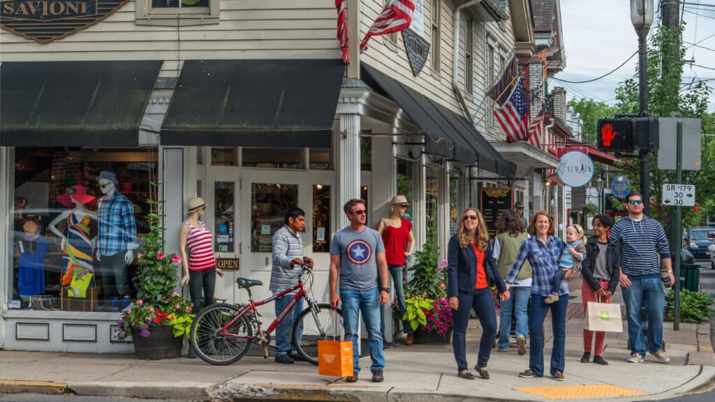 Group of people standing on busy intersection in New Hope, PA, Bucks County - Exploring vibrant shops and attractions in historic town.