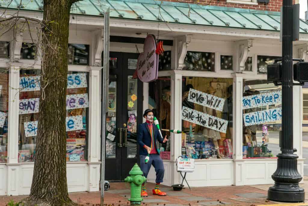Man juggling in front of Love Saves the Day vintage shop in New Hope, PA, Bucks County - Street performer adds charm to historic town.