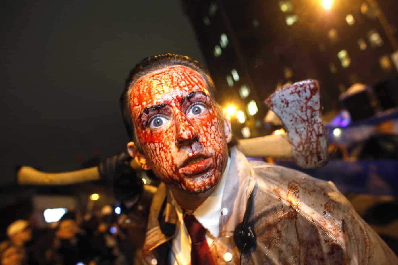 A friendly man with spooky makeup and a knife, ready to scare you with his Halloween costume at New York's Village Halloween Parade -- a top LGBTQ+ Halloween event