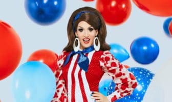 drag queen in red white and blue with balloons