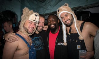 Four friends having a blast at Spooky Bear in Provincetown wearing bear hats and trendy overalls.