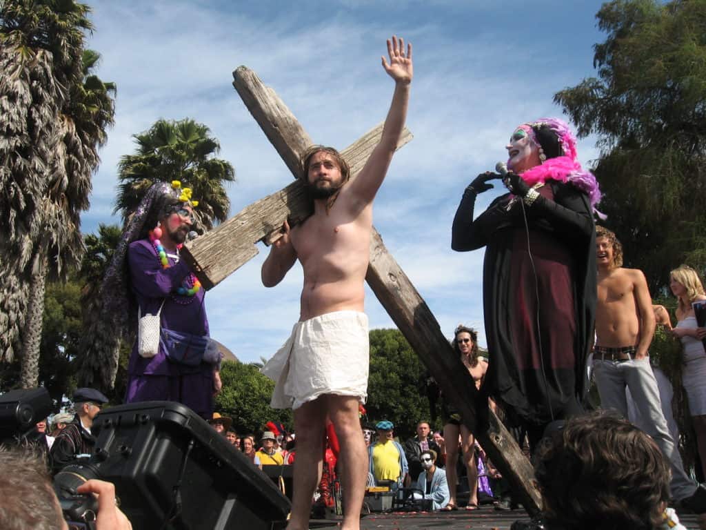 Two members of The Sisters of Perpetual Indulgence pose with a contestant at the Hunky Jesus and Foxy Mary contest in San Francisco. The Sisters of Perpetual Indulgence, a charitable organization, participate in the annual event celebrating diversity and inclusivity.