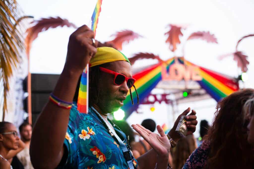 Gay man enjoying a gay pride celebration, showcasing Pride season celebration tips for a joyful and inclusive experience.