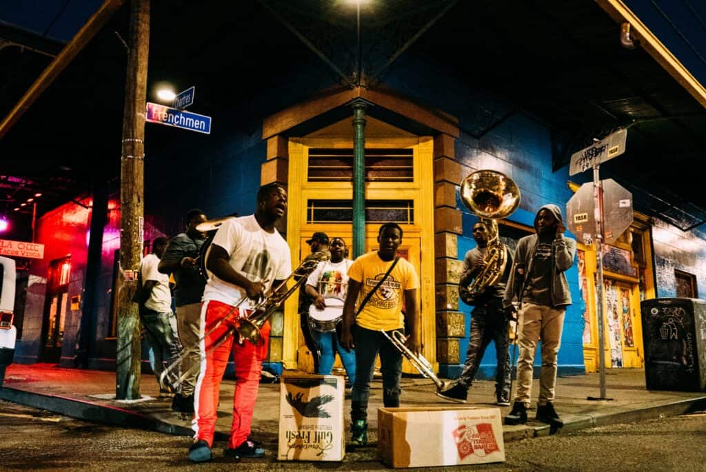 Group of African American men performing on the street in New Orleans, showcasing the vibrant culture and entertainment of the city.