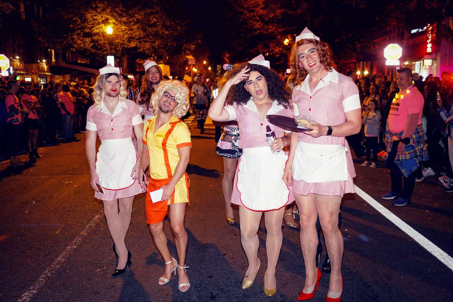 Group of guys in drag wearing waitress costumes with high heels for the 17th Street High Heel Race, a top LGBTQ+ Halloween event in Washington DC