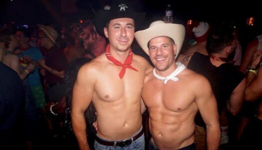 two shirtless guys wearing cowboy hats and jeans for a travel-inspired Halloween costume.