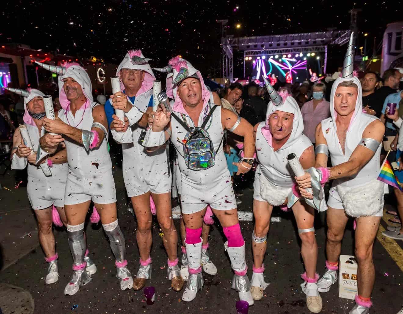 Group of guys dressed at unicorns for Halloween Palm Springs on Arenas Road, a top LGBTQ+ Halloween event