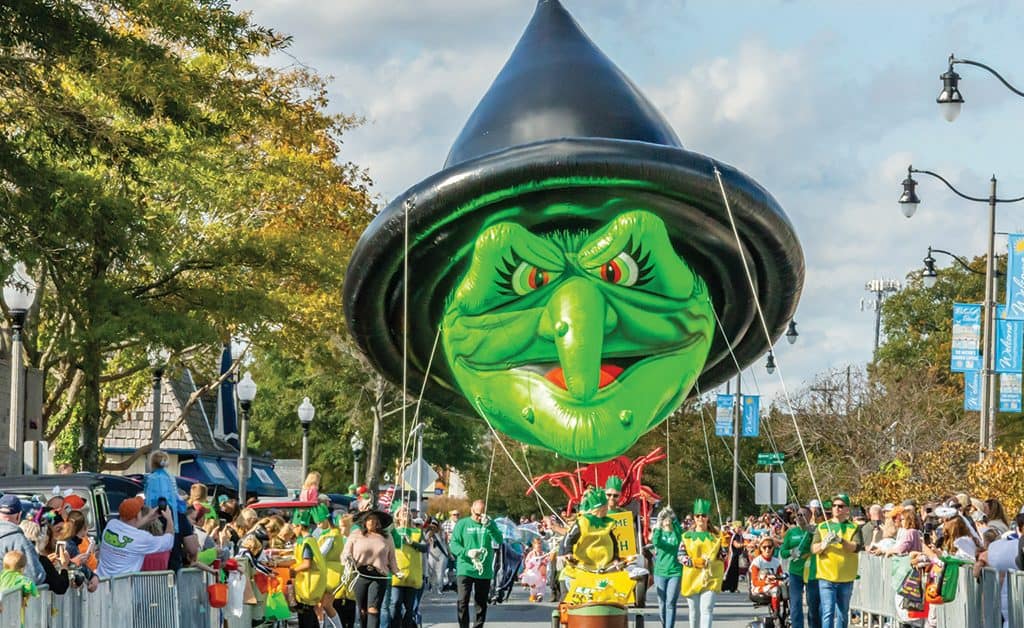 A jolly green witch balloon happily glides along the street, spreading Halloween cheer at Rehoboth Beach Sea Witch Halloween event