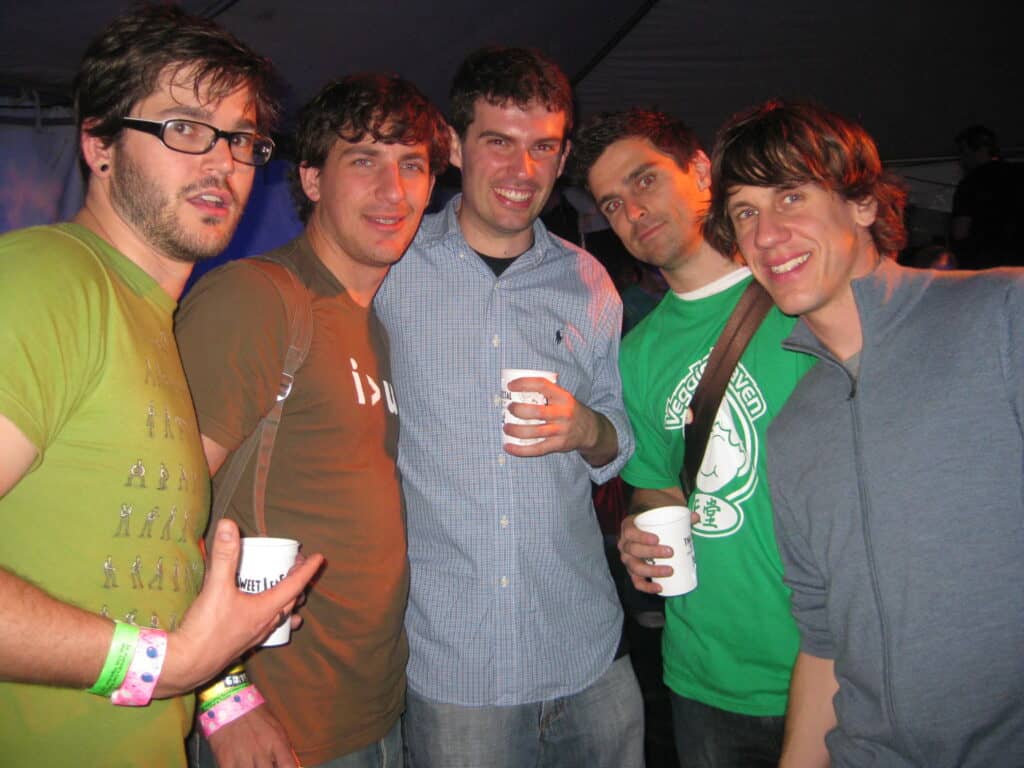 Group of LGBTQ+ men networking at a South by Southwest (SXSW) event in Austin, Texas, celebrating diversity and inclusion.