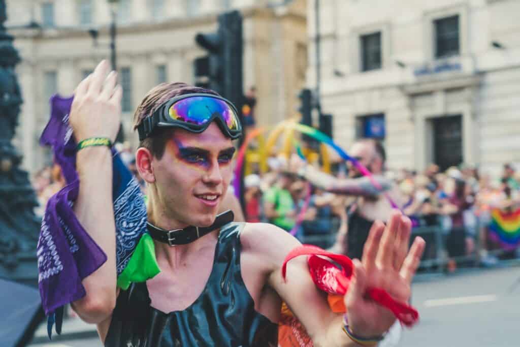 Gay man participating in London Pride Parade, celebrating LGBTQ+ diversity and inclusion.
