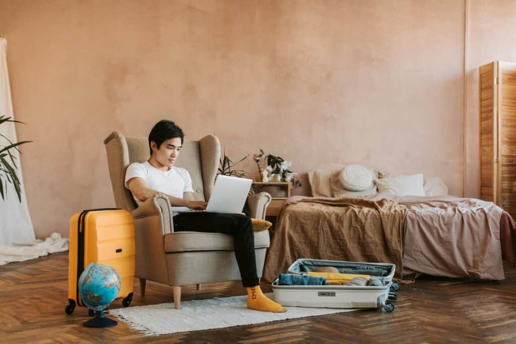 Traveler researching the Government Shutdown Travel Impact while packing luggage at home before a trip.
