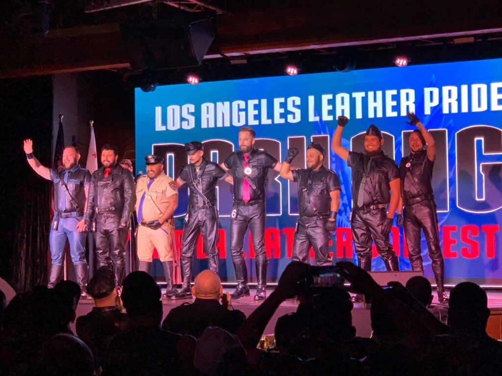 Group of gay men embracing at LA Leather Pride, showcasing diversity and unity in spring LGBTQ+ pride celebrations.