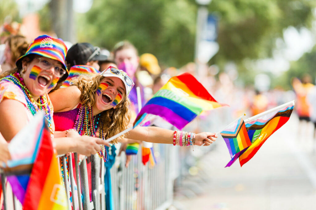 Spectators joyfully celebrating at Tampa Pride parade, showcasing diversity and inclusion in spring LGBTQ+ pride events.