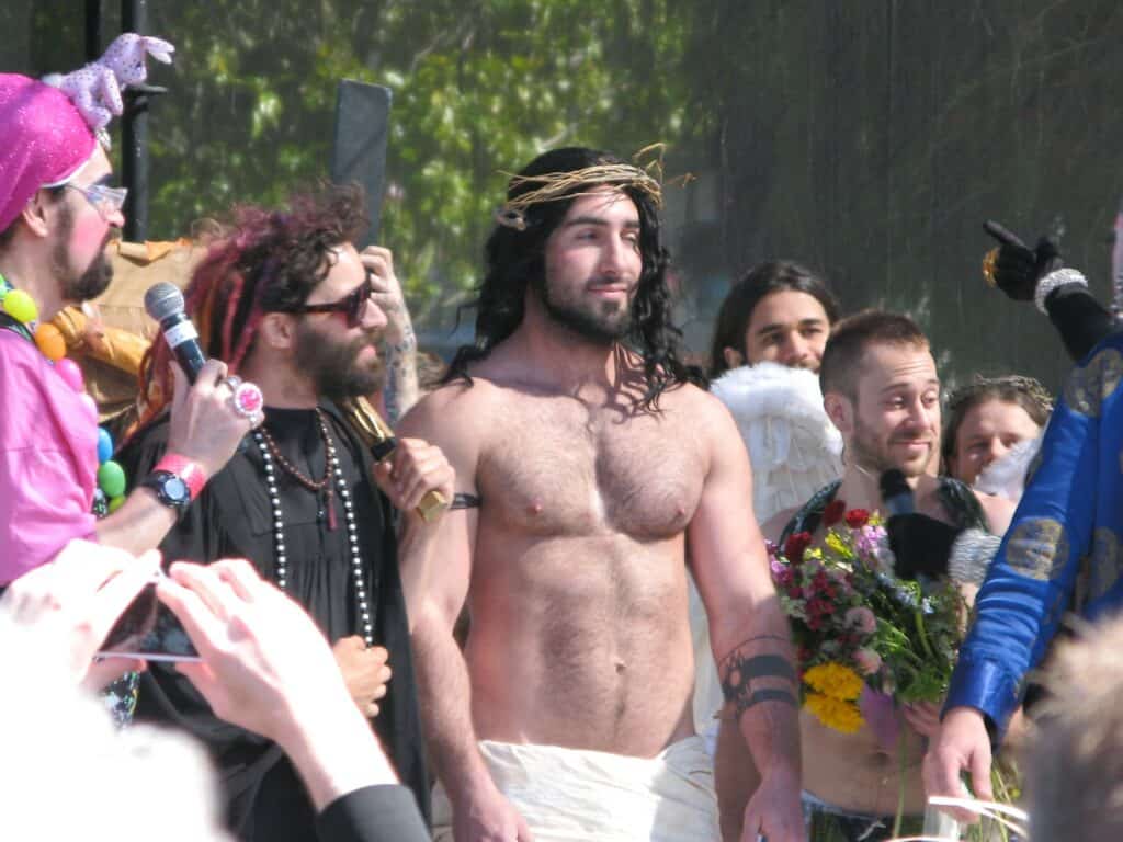 A participant showcasing muscular physique at the Hunky Jesus and Foxy Mary contest in San Francisco, celebrating diversity and inclusivity in the LGBTQ+ community.