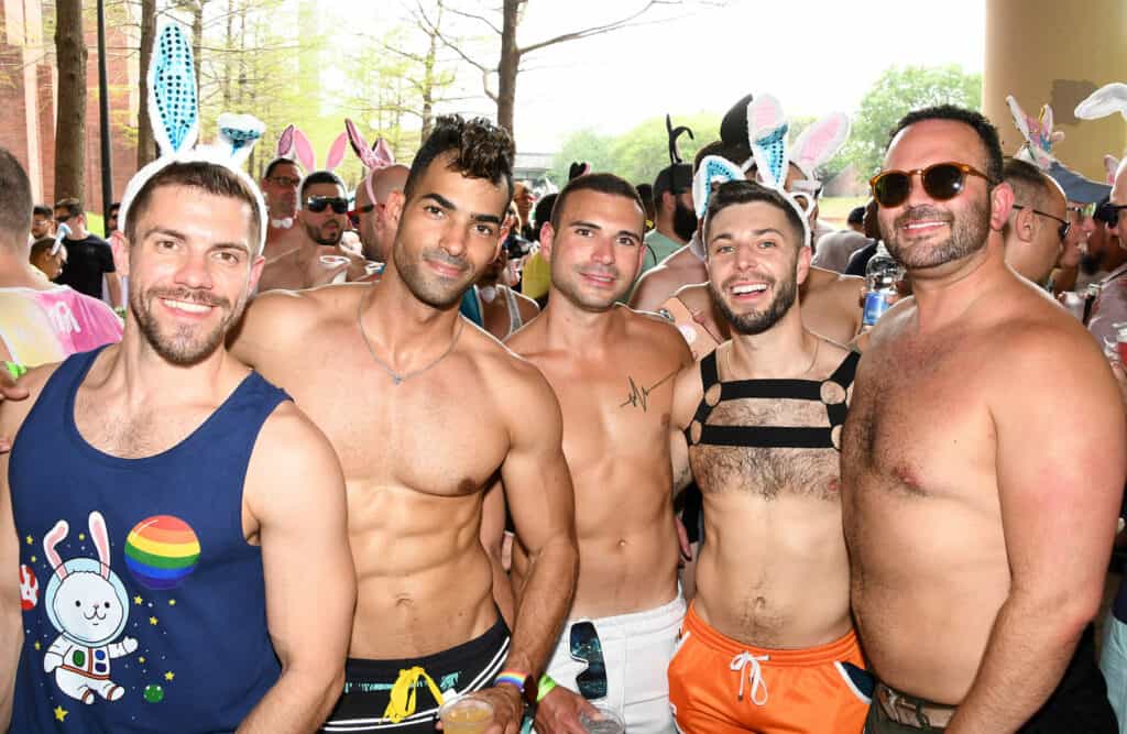 Group of five men, some shirtless and some wearing bunny rabbit ears at Bunnies on the Bayou event in Houston, Texas, representing LGBTQ+ Easter celebrations and gay-friendly getaways.