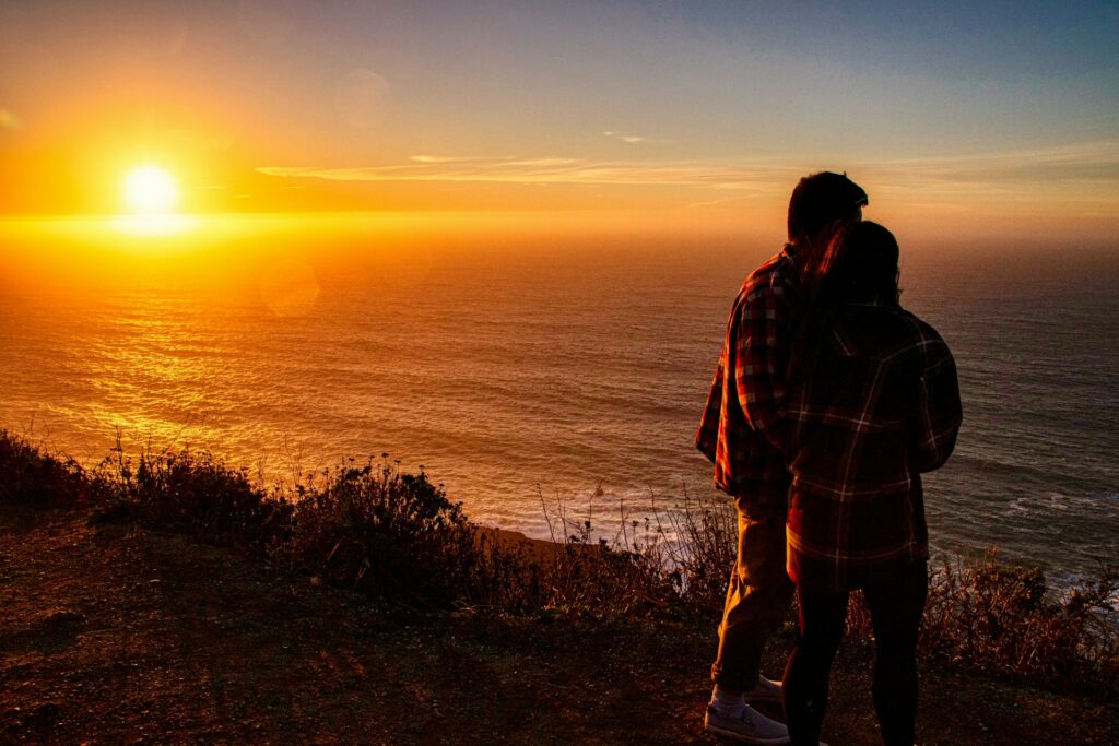 Sunset over the Pacific coastline, ideal for LGBTQ+ spring road trips in California. Explore the beauty with your loved one!