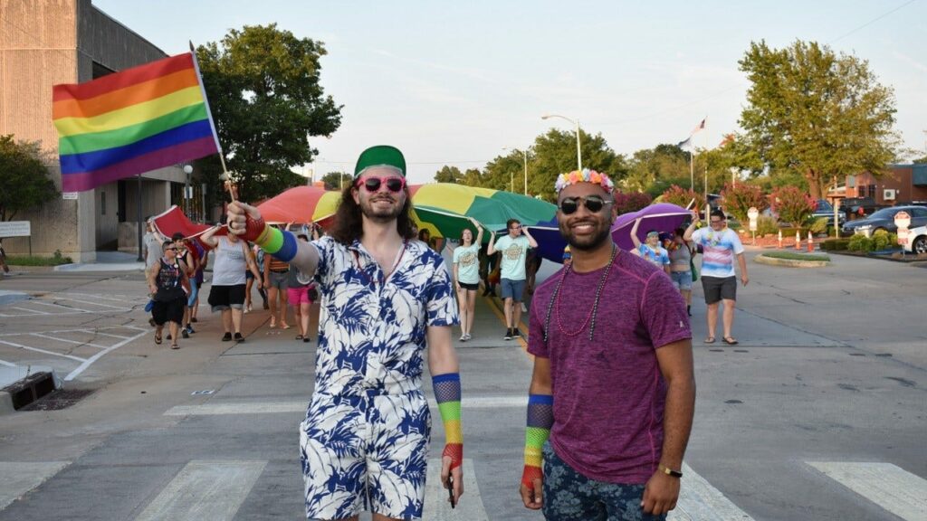 Participants joyfully celebrating at Norman, OK Pride parade, highlighting diversity and inclusion in spring LGBTQ+ pride events.