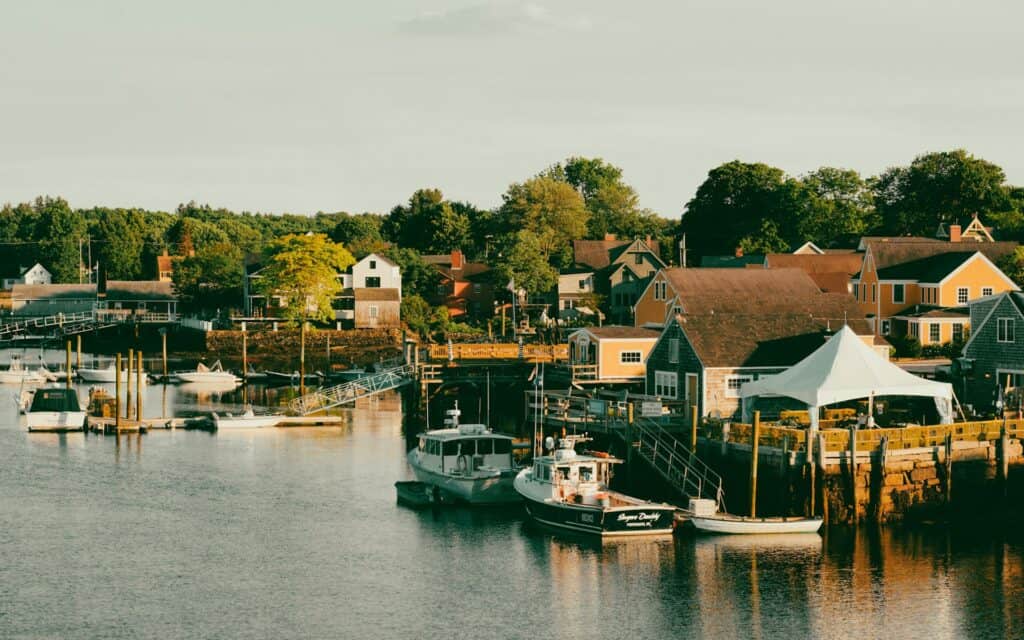 Portsmouth, NH harbor filled with small boats, offering scenic views for visitors. Explore maritime charm in Portsmouth on your trip.