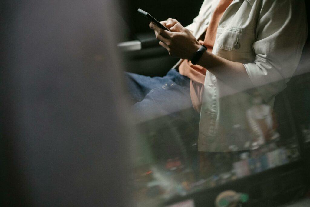 Man using cell phone to explore travel apps.