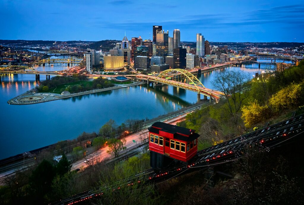 Pittsburgh skyline, featuring the city's iconic bridges and downtown architecture. Explore urban charm on your Keystone state road trip.
