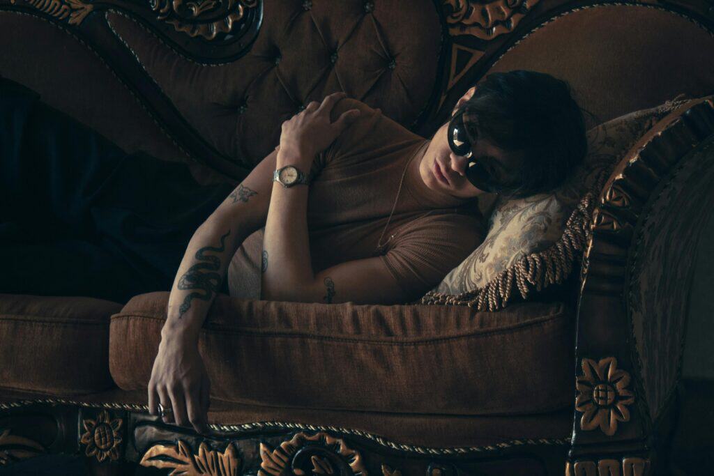 Moody Portrait of a Relaxed Man on Vintage Sofa after a night exploring the Berlin gay nightlife experience at Lab.oratory.
