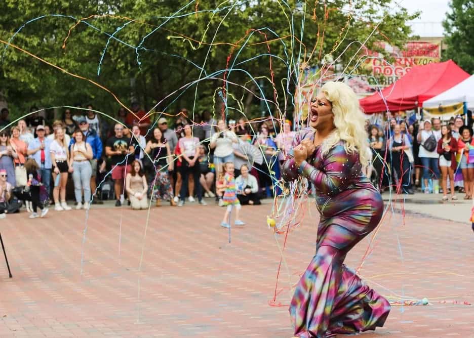 Drag queen performing at Asheville Pride festival with a cheering crowd, one of the highlights of fall Pride events 2025.