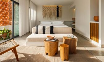 Modern guest room design at Tryst hotel Wilton Manors, featuring warm wood accents, neutral tones, and a relaxed luxury feel.