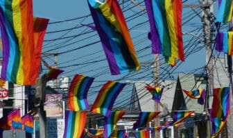 Rainbow flags lining Commercial Street in Provincetown on a bright summer day