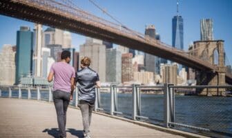 LGBTQ+ travelers exploring an LGBTQ-friendly neighborhood while visiting a major city.
